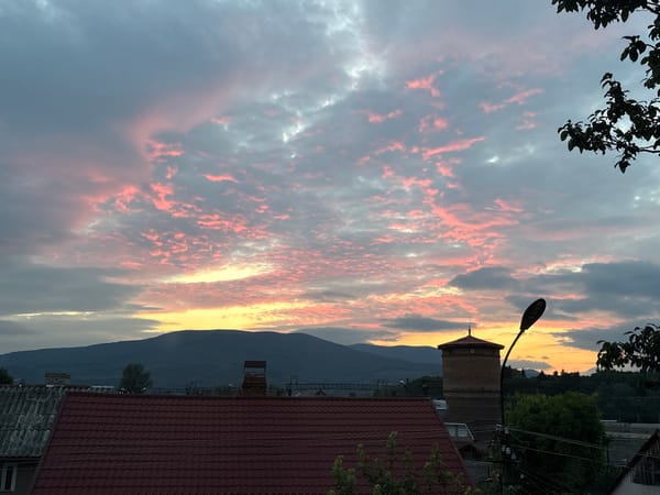 Sunset clouds over a rural mountain town
