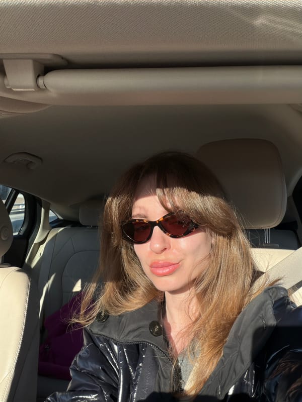 Woman drives through Moscow suburbs in sunny afternoon