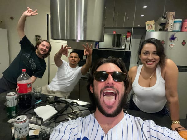 Four friends take group selfie in Mexico City kitchen