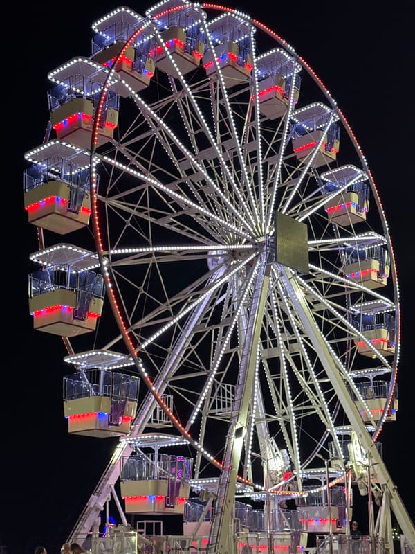 Carnival night in Vlora: Ferris wheel, carousel, and fire spinners