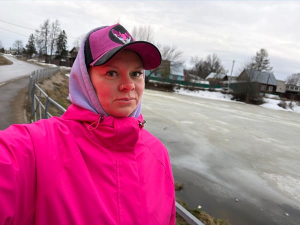 Woman poses by frozen lake in Chaikovsky, Russia