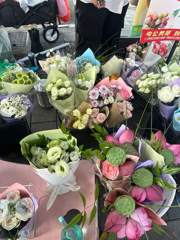 Street vendors and flower stalls on a Chongqing sidewalk