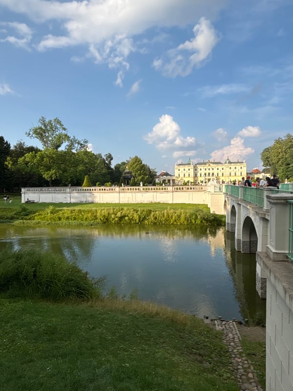 Branicki Palace gardens, fountains, and statues on a clear afternoon