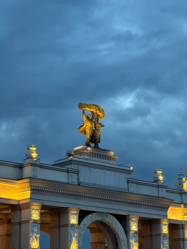 Moscow harvest wreath statue observed atop illuminated building