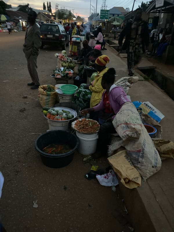 Roadside goods laid out at dusk in Bukuru, Nigeria