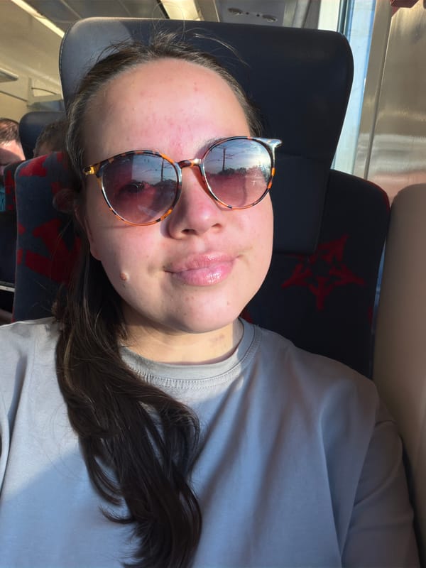 Woman rests on patterned train seat in Moscow