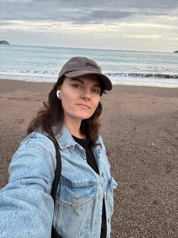 Beachgoers photographed at Rafailovići under cloudy skies