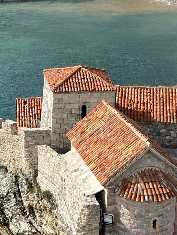 Tourist explores historic Budva Montenegro coastline and old town