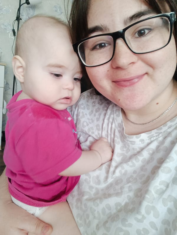Woman and infant photographed in tender moment, Noviy Russia