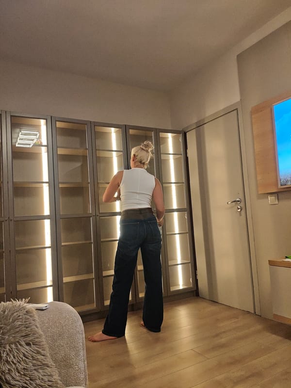 Woman examines furniture, cityscape views captured in residential setting
