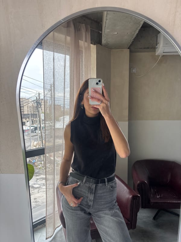 Woman takes mirror selfie in Zovuni, Armenia building