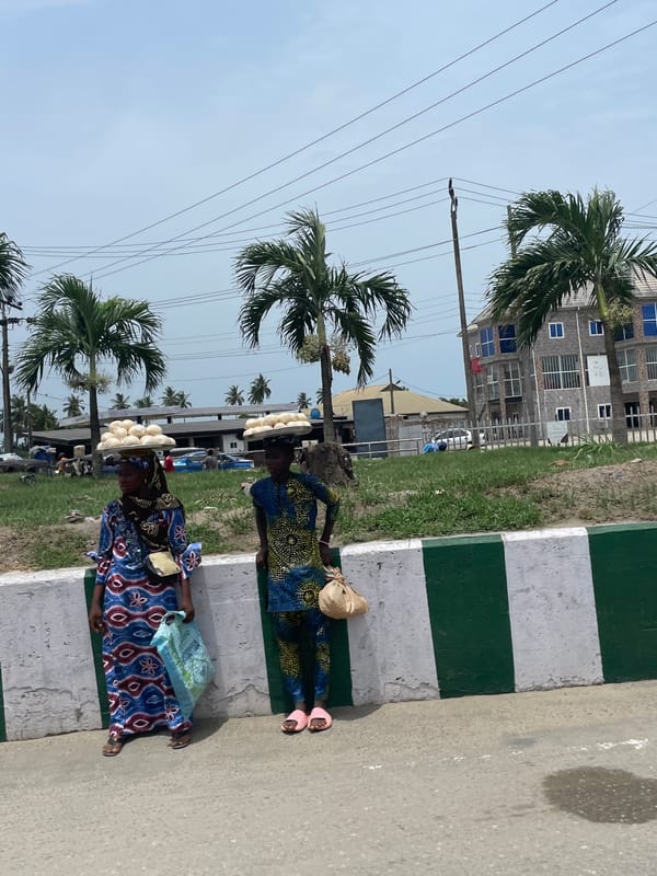 Street vendors sell food on Badagry sidewalks