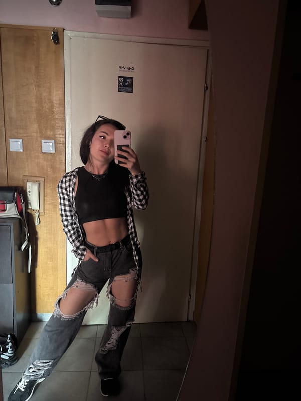 Woman takes mirror selfie in casual outfit