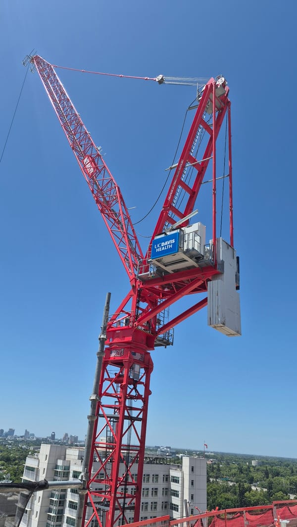 UC Davis Health tower crane rising over Sacramento construction site