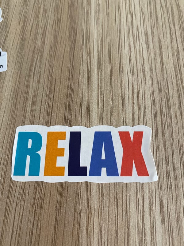 Sticker collection and Armenian everyday objects on a wooden surface