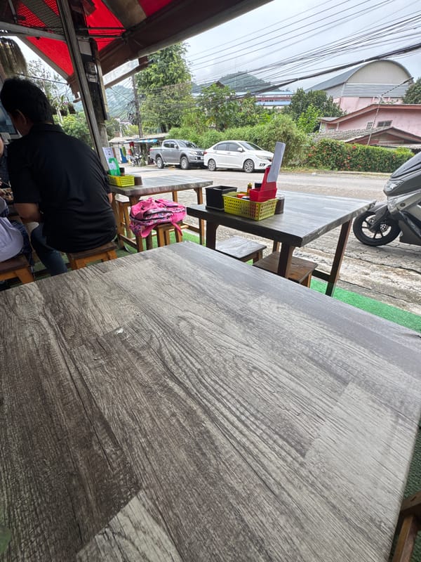 Drinks on a wooden table at a Kathu outdoor eatery
