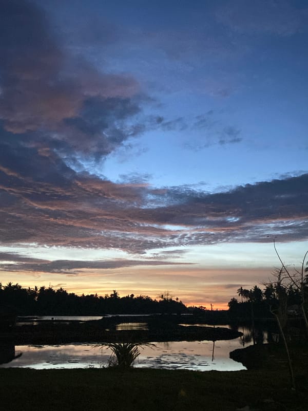 Waterside scene captured at dusk in Seuneubok Teungoh, Indonesia