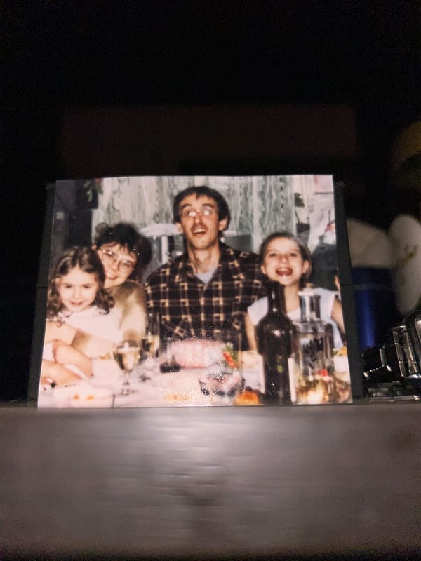 Family of four photographed sharing meal at table