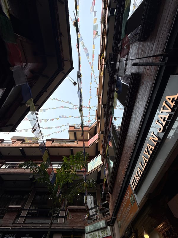 Morning coffee walk through prayer flag-lined Kathmandu streets