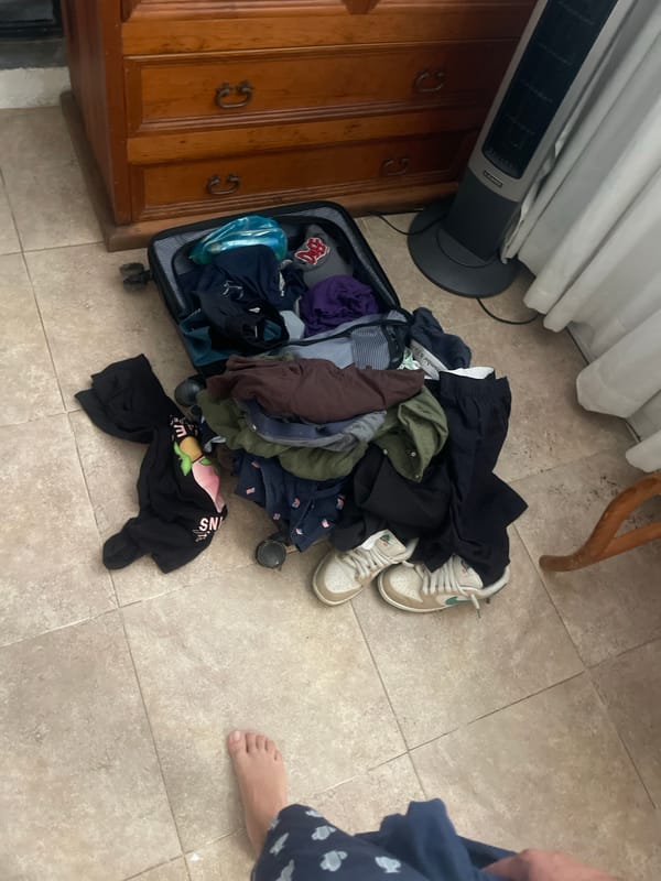 Overflowing suitcase with clothes documented in Oaxaca City residence