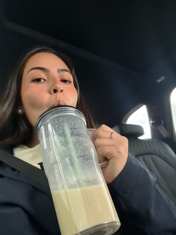Woman enjoys smoothie in car in Ixtapaluca
