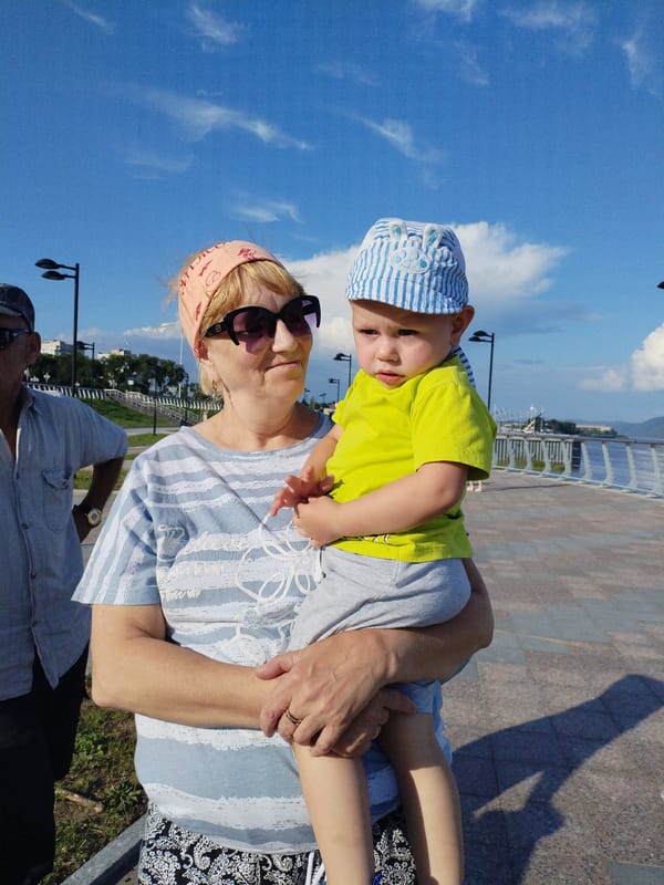 Family outing along a sunny waterfront promenade