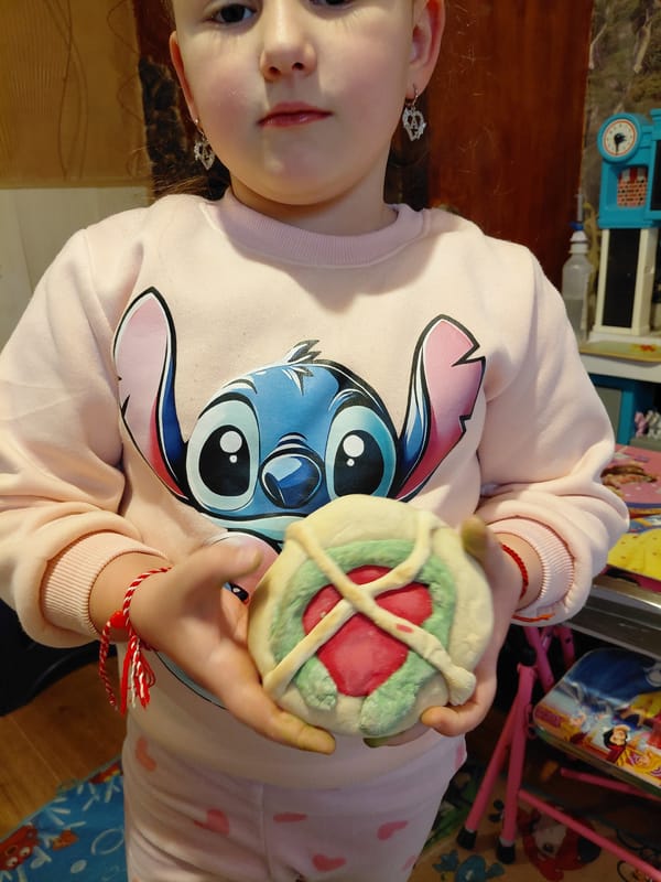 Young girl displays handmade cookies and artwork in Sofia