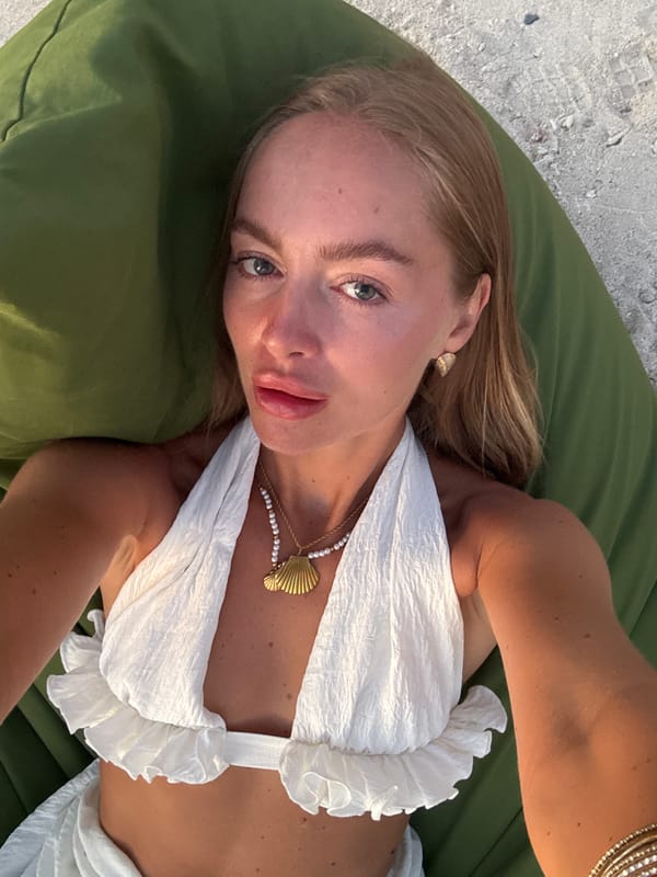 Woman relaxes on beach cushion in Indonesia