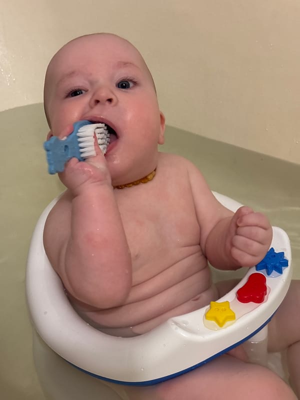 Baby enjoys bath time with teething toys in Russia