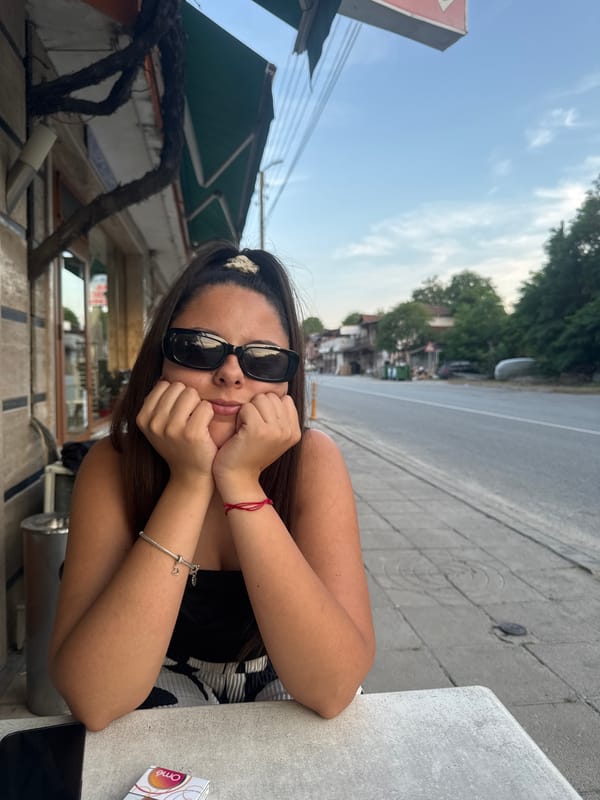 Woman photographed at outdoor table in Bulgarian village