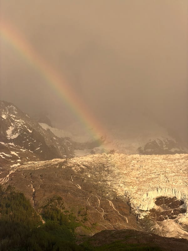 Rainbow over Mont Blanc under a hazy evening sky