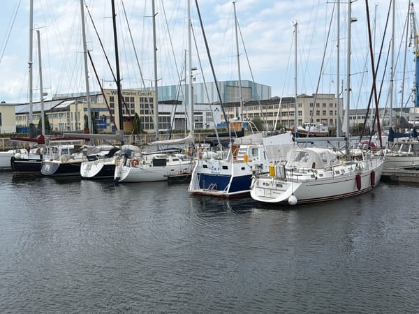 Wismar harbor packed with sailboats on a grey summer day