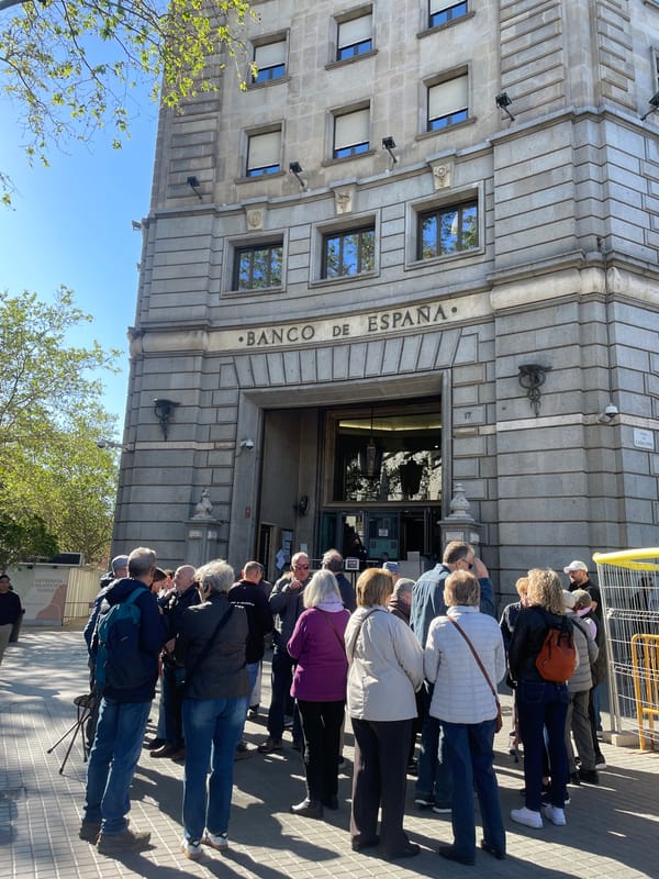 Barcelona residents queue at bank amid Sant Jordi preparations