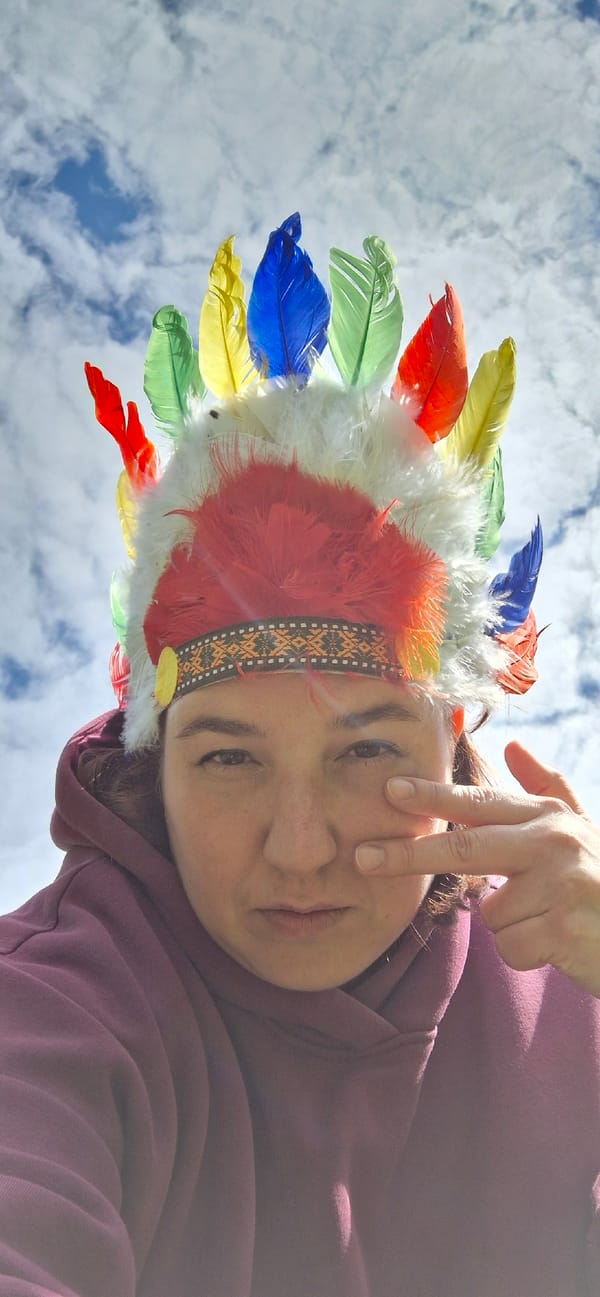 Person in feathered headdress photographed at Russian recreational area