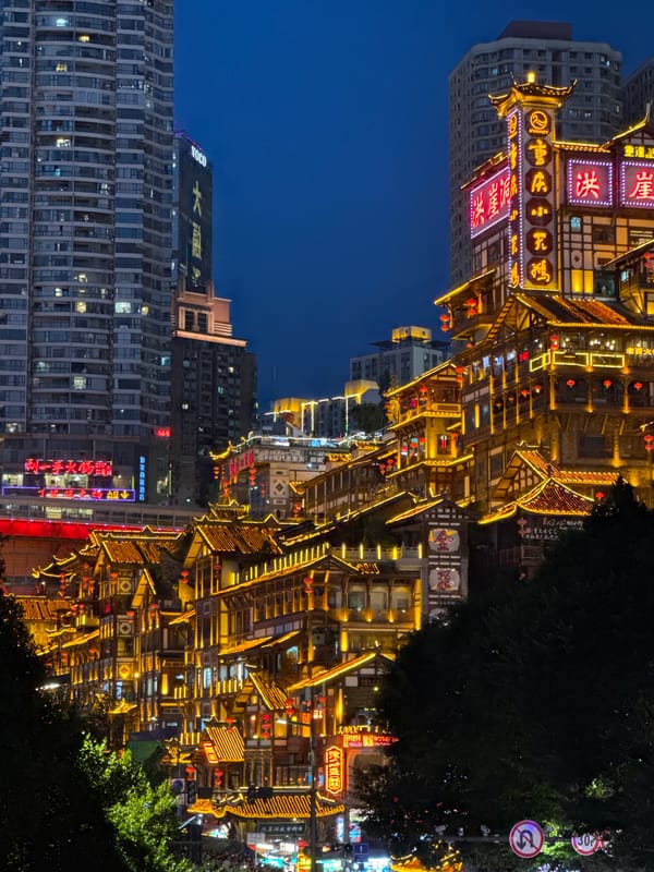 Chongqing's Hongyadong and riverfront bridge lit up at night