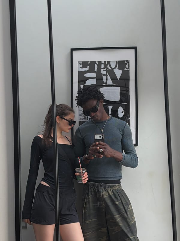 Couple captured in mirror reflection in London