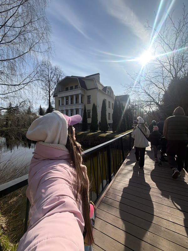 Woman in pink explores Saint Petersburg park on sunny afternoon