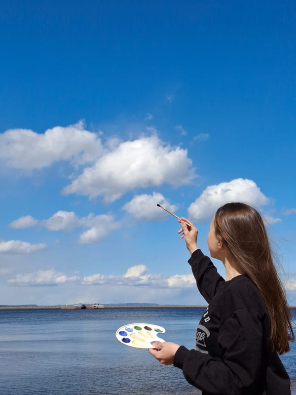 Person photographs artistic poses by waterfront in Chaikovsky Russia