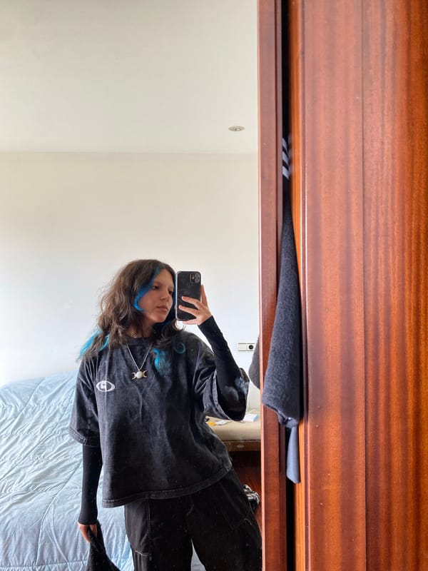 Woman takes mirror selfie in Gijón, Spain