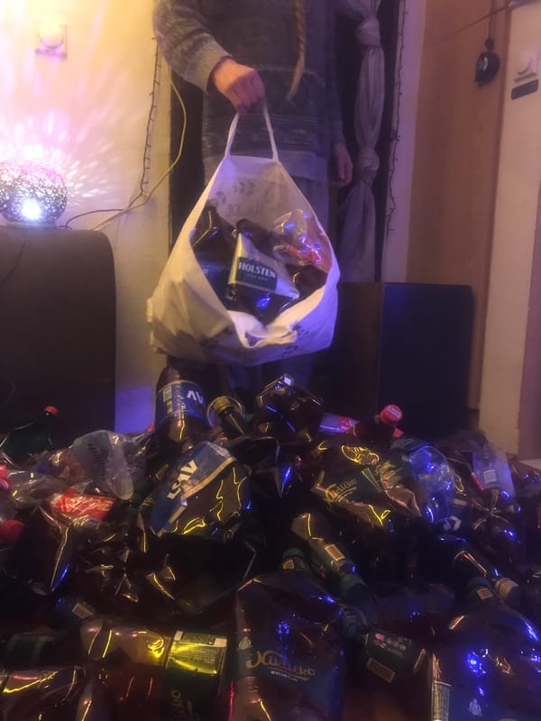 Person empties bags of bottles in debris-covered residence