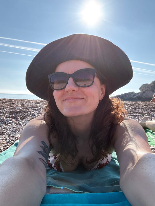 Woman enjoys strawberries on Montenegro beach during sunny afternoon