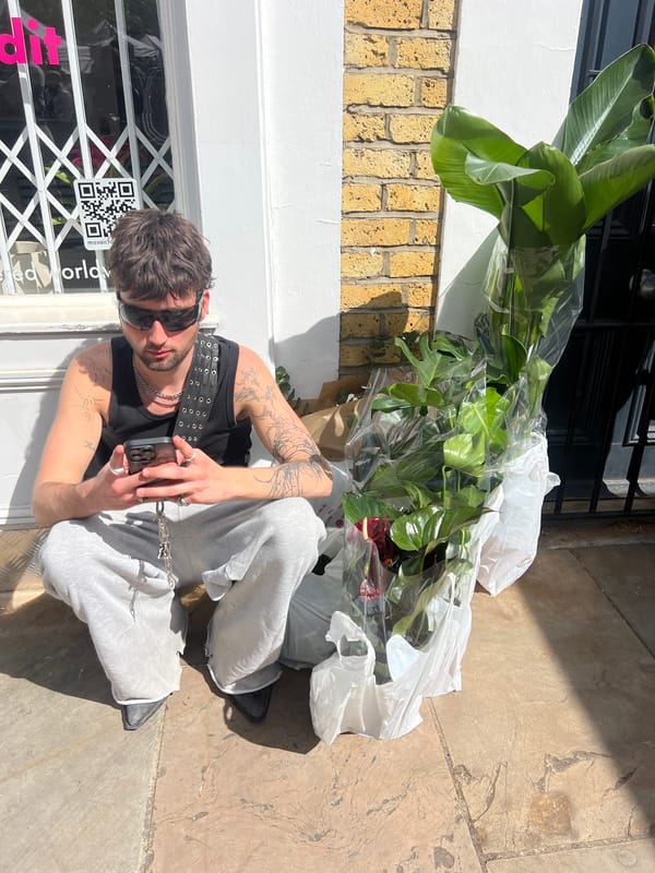 Man sits outside closed London shop
