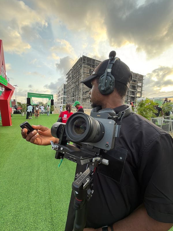 Video producer with equipment documented on Lagos artificial turf