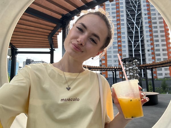 Woman in yellow shirt documents morning selfie tour across city