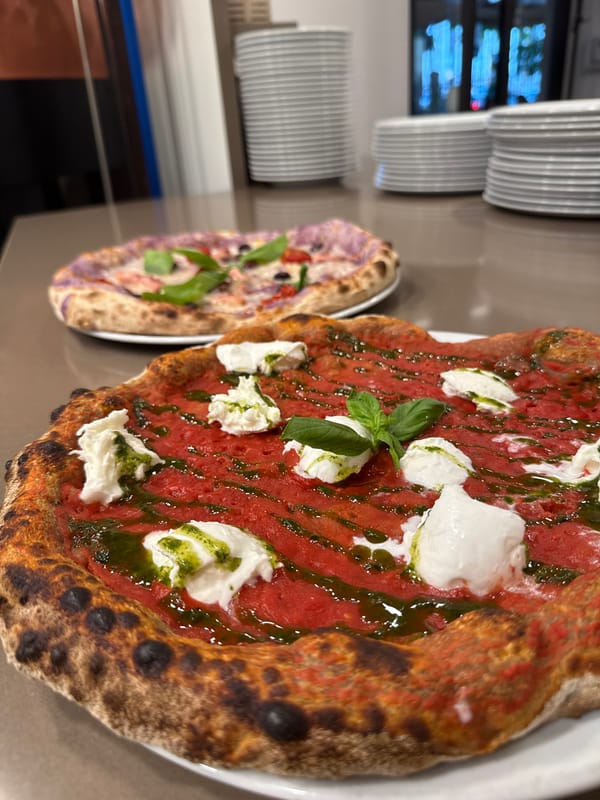 Pizza and plates at a Trento restaurant, late July afternoon