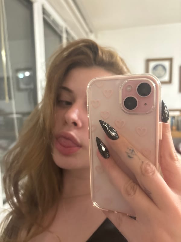 Woman takes bathroom mirror selfies in Troyan, Bulgaria