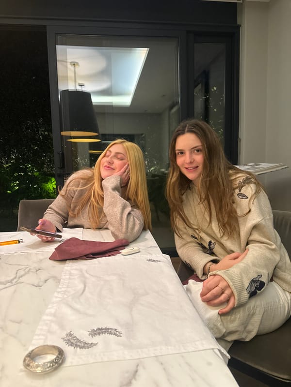 Women share morning pastries at marble table