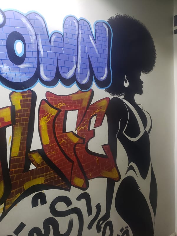 Nighttime scenes captured in Adankolo include street art and dining