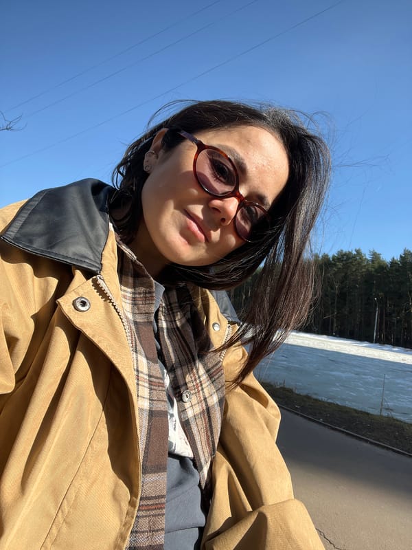 Woman takes selfies at frozen waterfront in Podolsk
