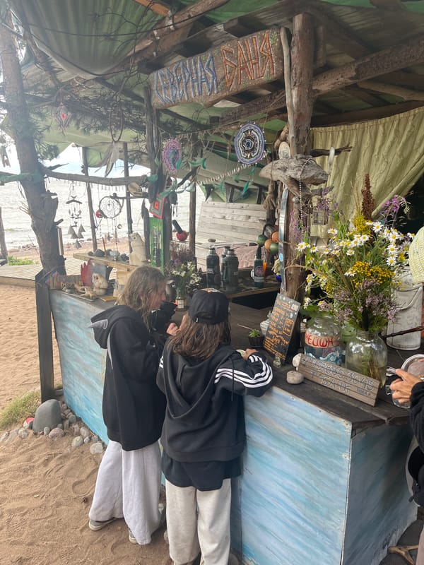 Instruments and art set up at a casual beachside gathering spot